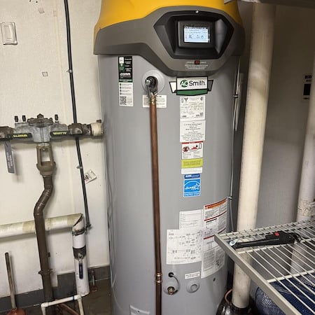 Modern water heater with digital display and copper pipes, inspecting for winter performance in Marietta